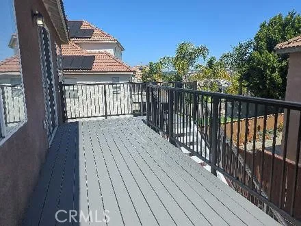 a view of roof deck with outdoor seating and covered with trees