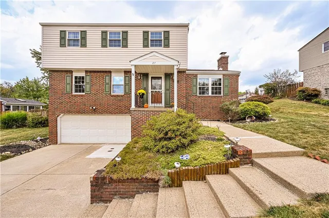 a front view of a house with a yard