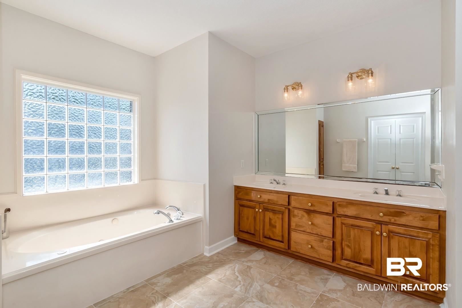6090 Celeste Road Saraland, AL 36571 - Photo 19 of 38 Full bath featuring double vanity, a bath, baseboards, and a sink
