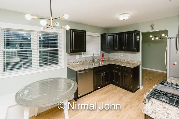 a spacious bathroom with a granite countertop sink and a large mirror