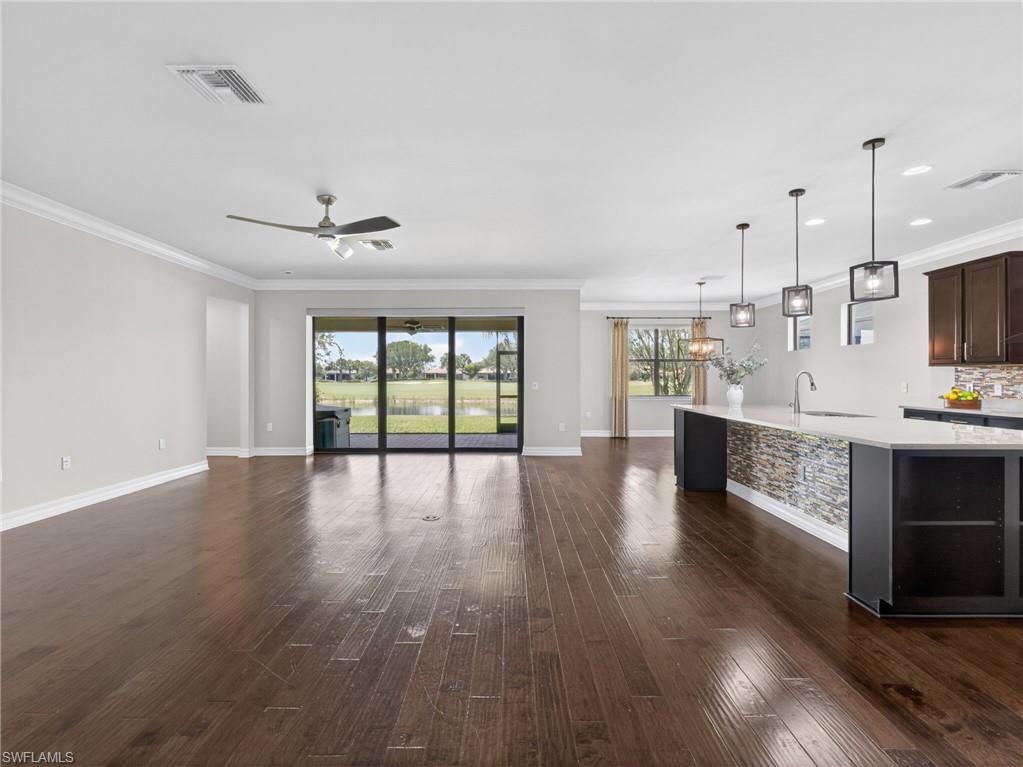 6124 Victory Drive Ave Maria, FL 34142 - Photo 13 of 50 a large kitchen with cabinets wooden floor and stainless steel appliances