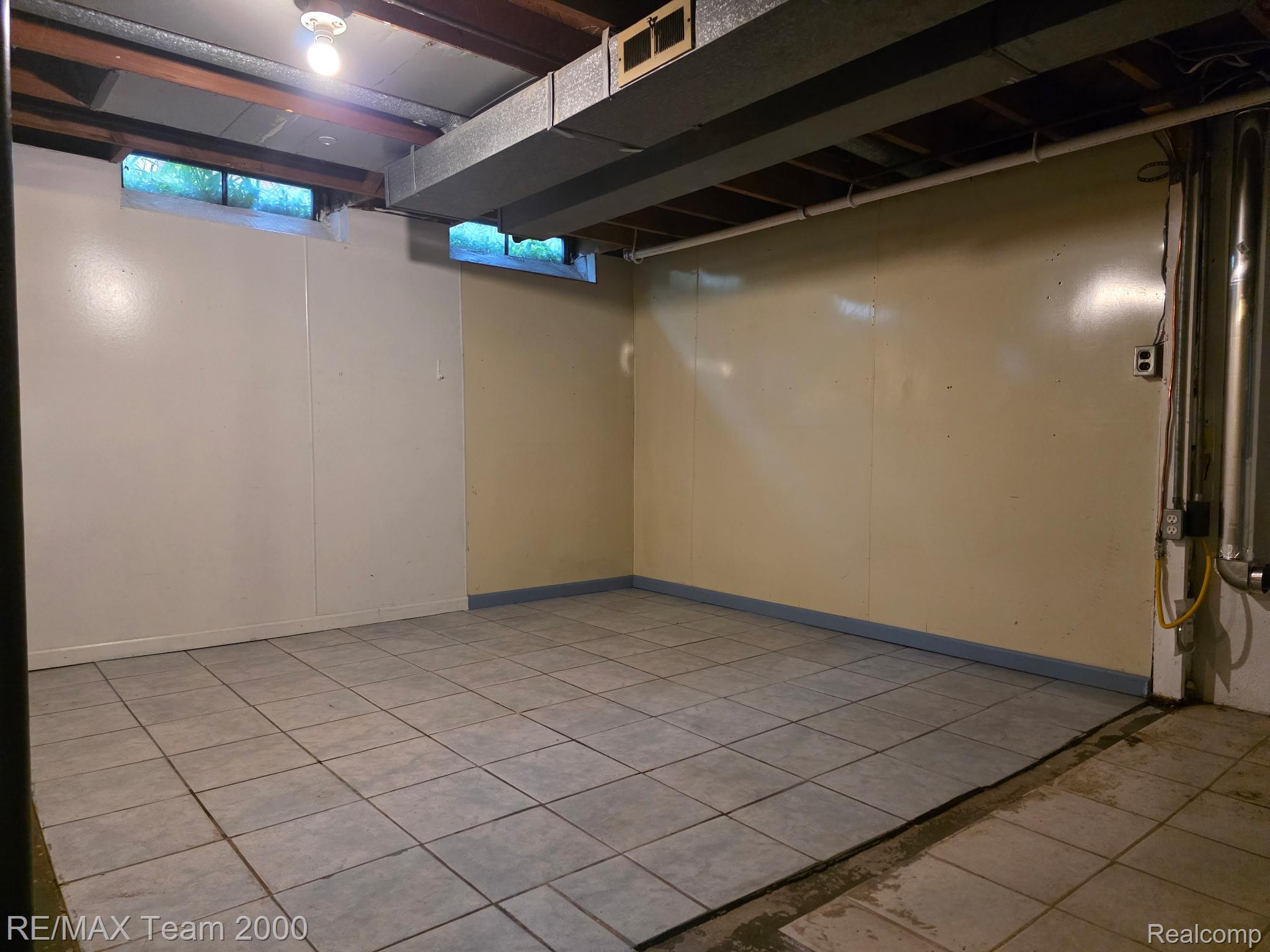 38114 Walnut Street Romulus, MI 48174 - Photo 13 of 18 Tiled flooring provides a durable surface throughout this expansive room