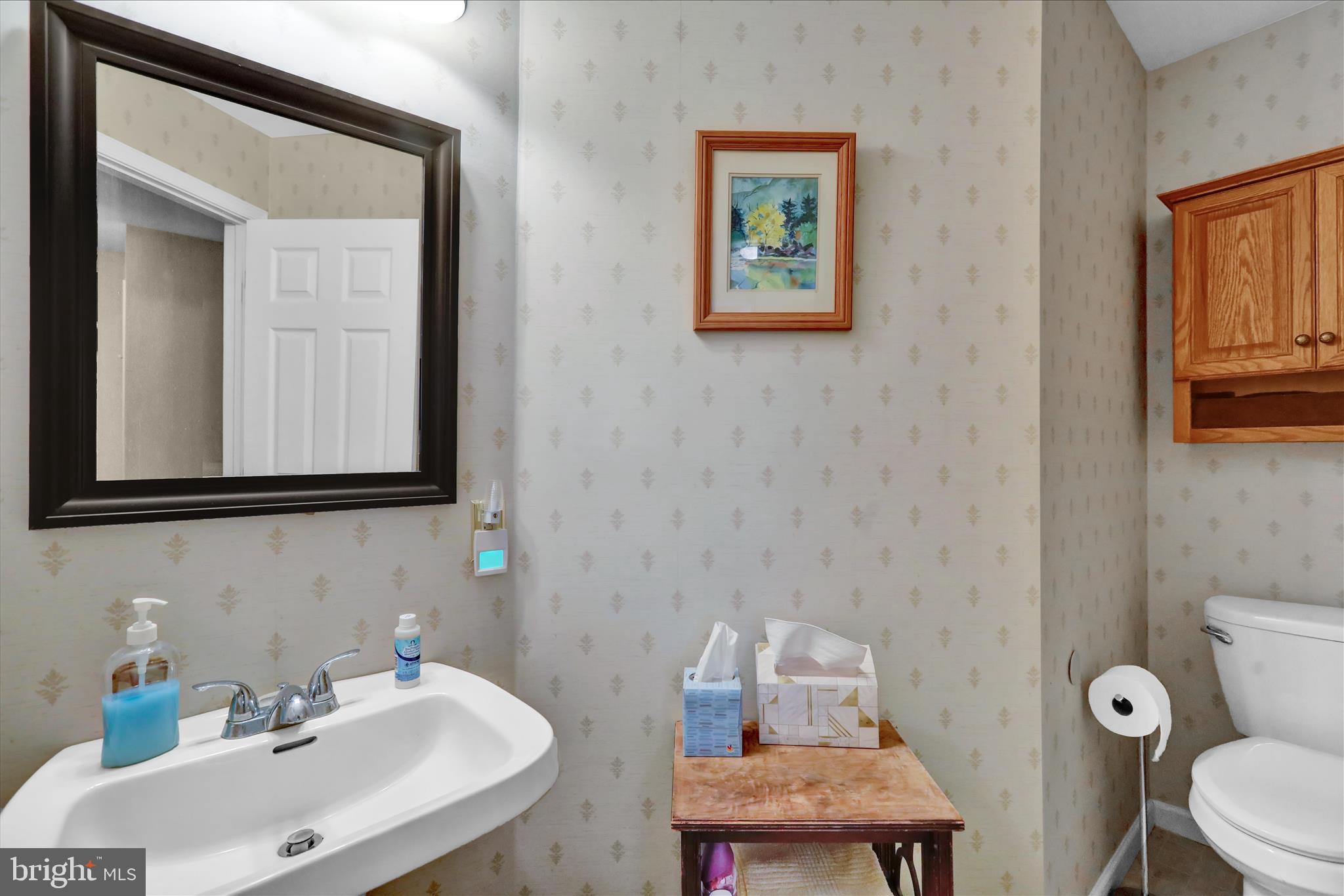 106 Heather Lane Reading, PA 19610 - Photo 13 of 23 a bathroom with a toilet a sink and mirror