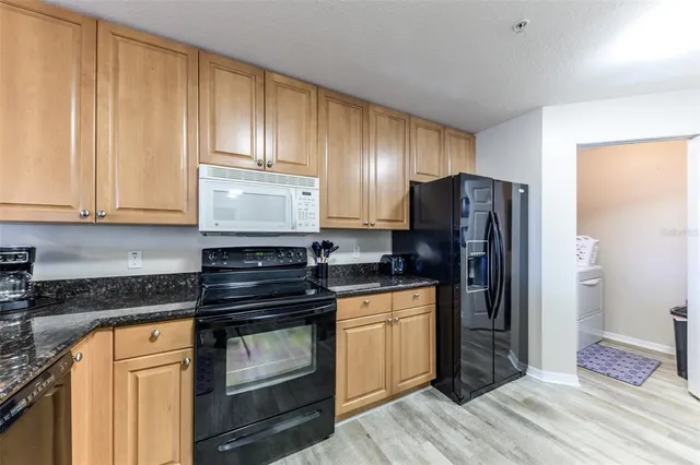 a kitchen with kitchen island a sink stove and cabinets