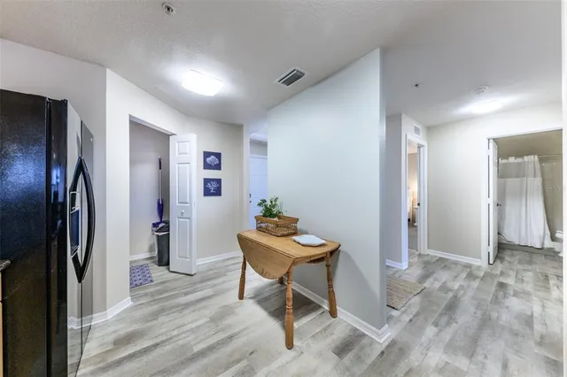 a bedroom with a bed chandelier and a window