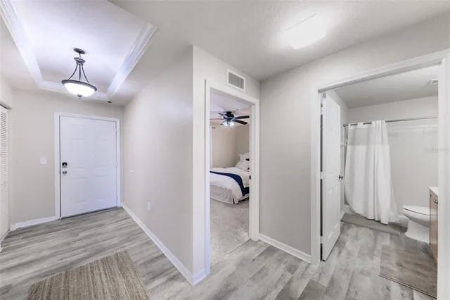 a bedroom with a bed and a chandelier