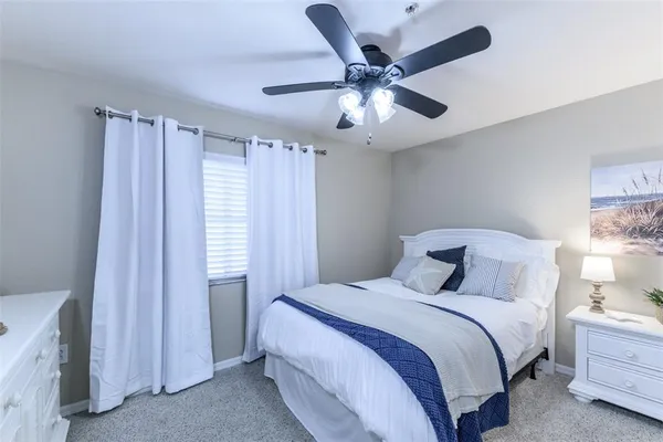 a hallway with mirror and cabinets