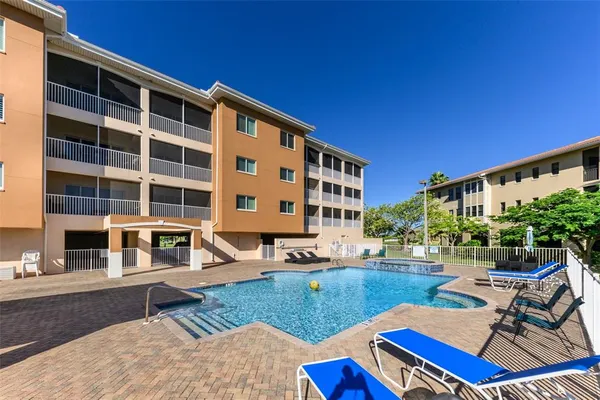 a view of a house with swimming pool and sitting area