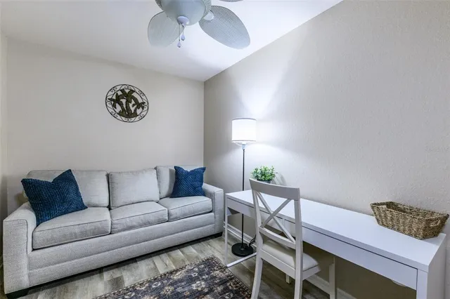 a living room with furniture a dining table and kitchen view