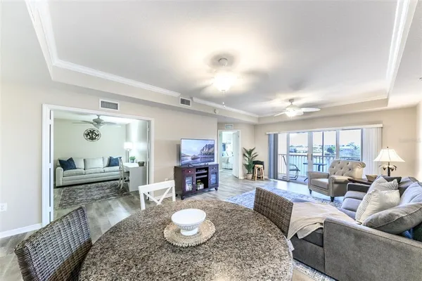 a view of a balcony with chairs and wooden floor