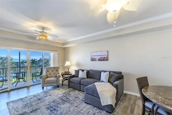 a living room with furniture and a dining table with wooden floor