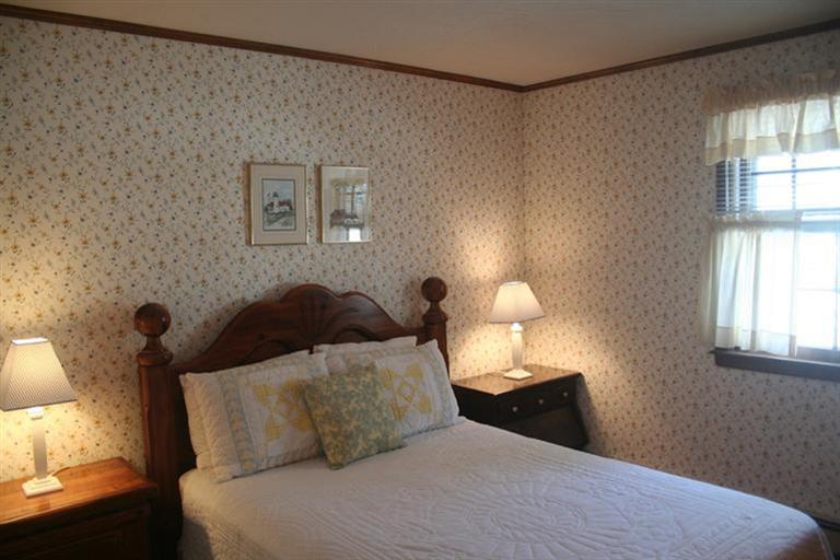 24 Eileen Road Chatham, MA 02633 - Photo 9 of 12 a bed room with a bed and a lamp