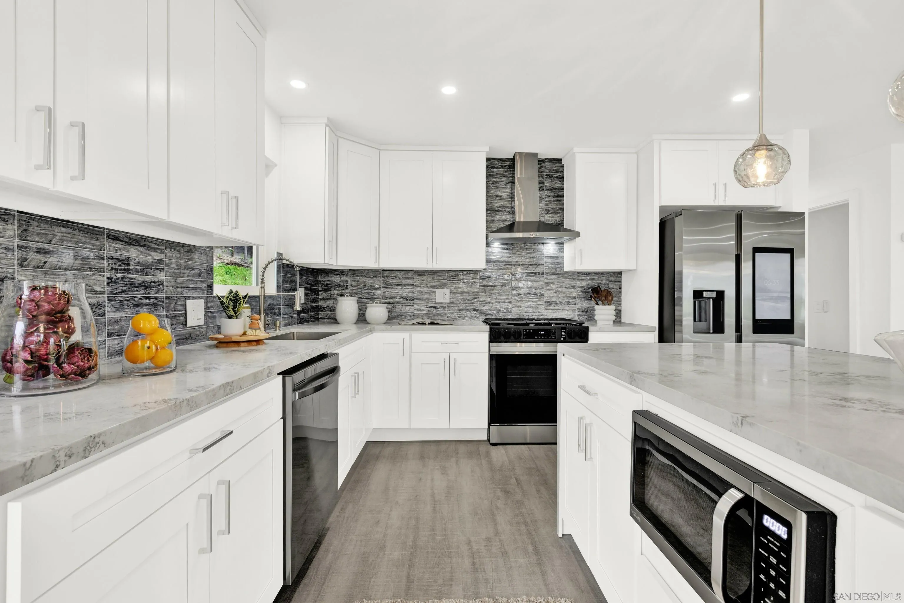 2250 Ivy Road Oceanside, CA 92054 - Photo 11 of 30 a kitchen with granite countertop stainless steel appliances and wooden cabinets