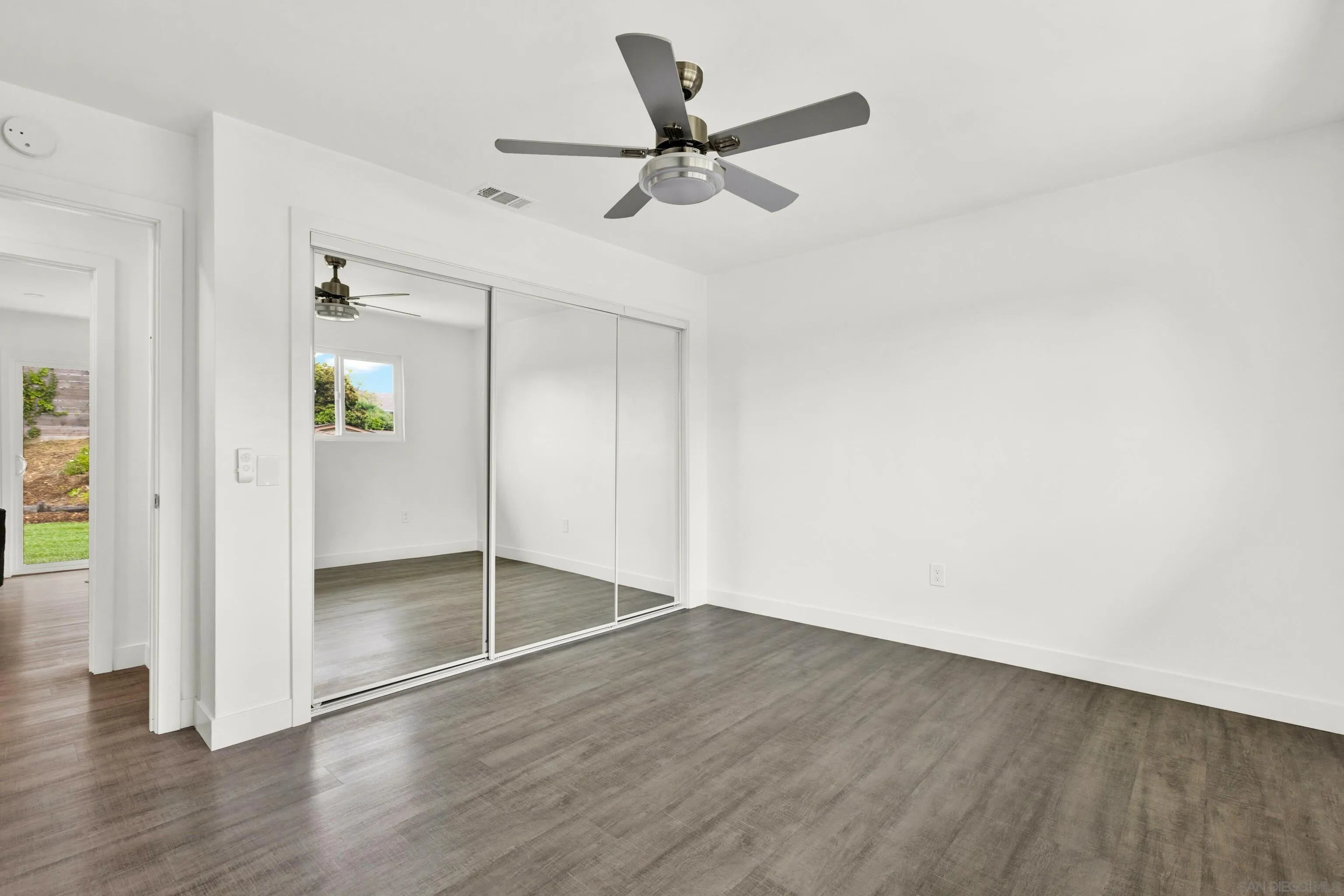 2250 Ivy Road Oceanside, CA 92054 - Photo 20 of 30 a view of a room with wooden floor and a ceiling fan