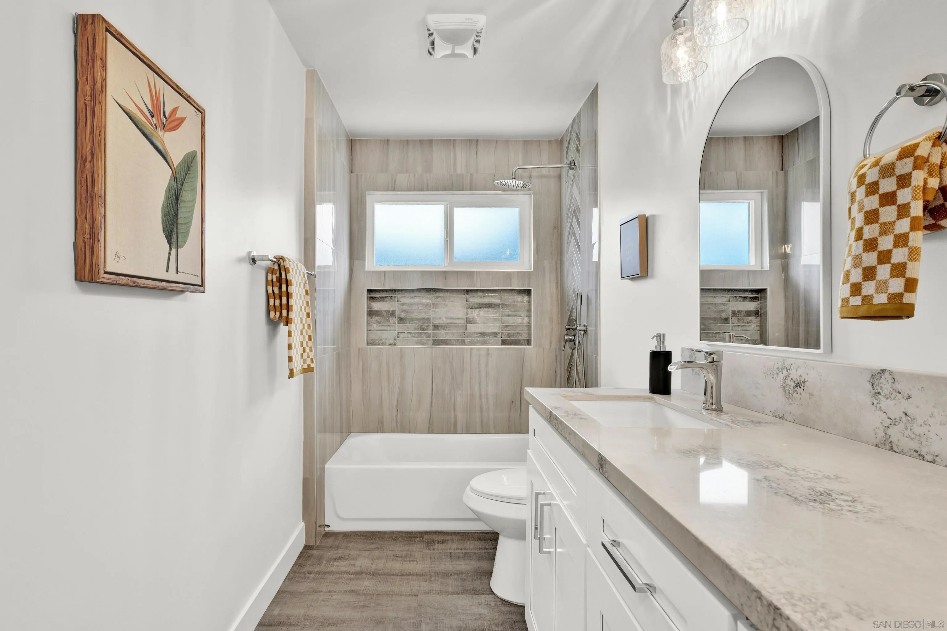 2250 Ivy Road Oceanside, CA 92054 - Photo 22 of 30 a bathroom with a granite countertop sink a toilet a mirror and shower