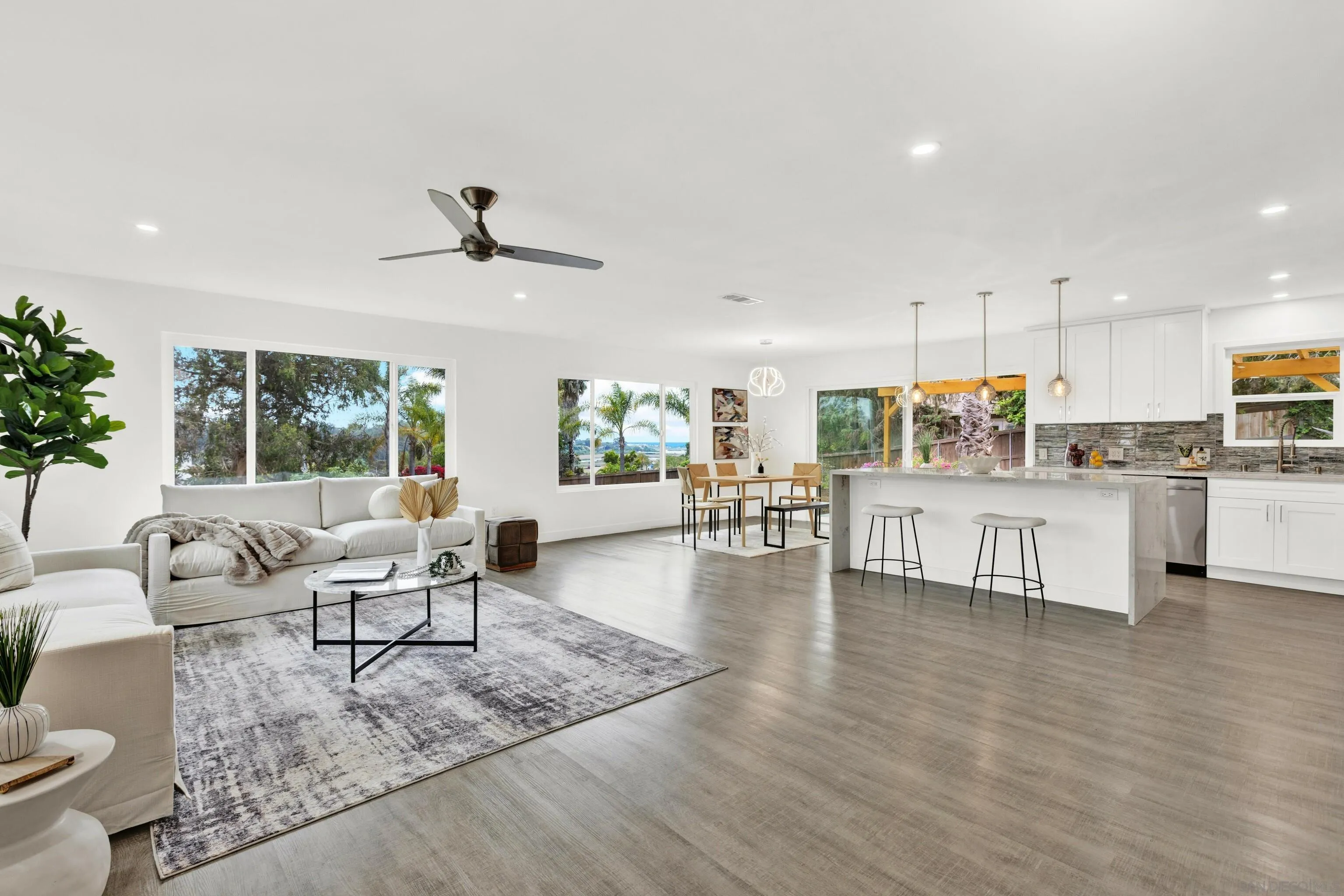 2250 Ivy Road Oceanside, CA 92054 - Photo 4 of 30 a living room with furniture and kitchen view with wooden floor