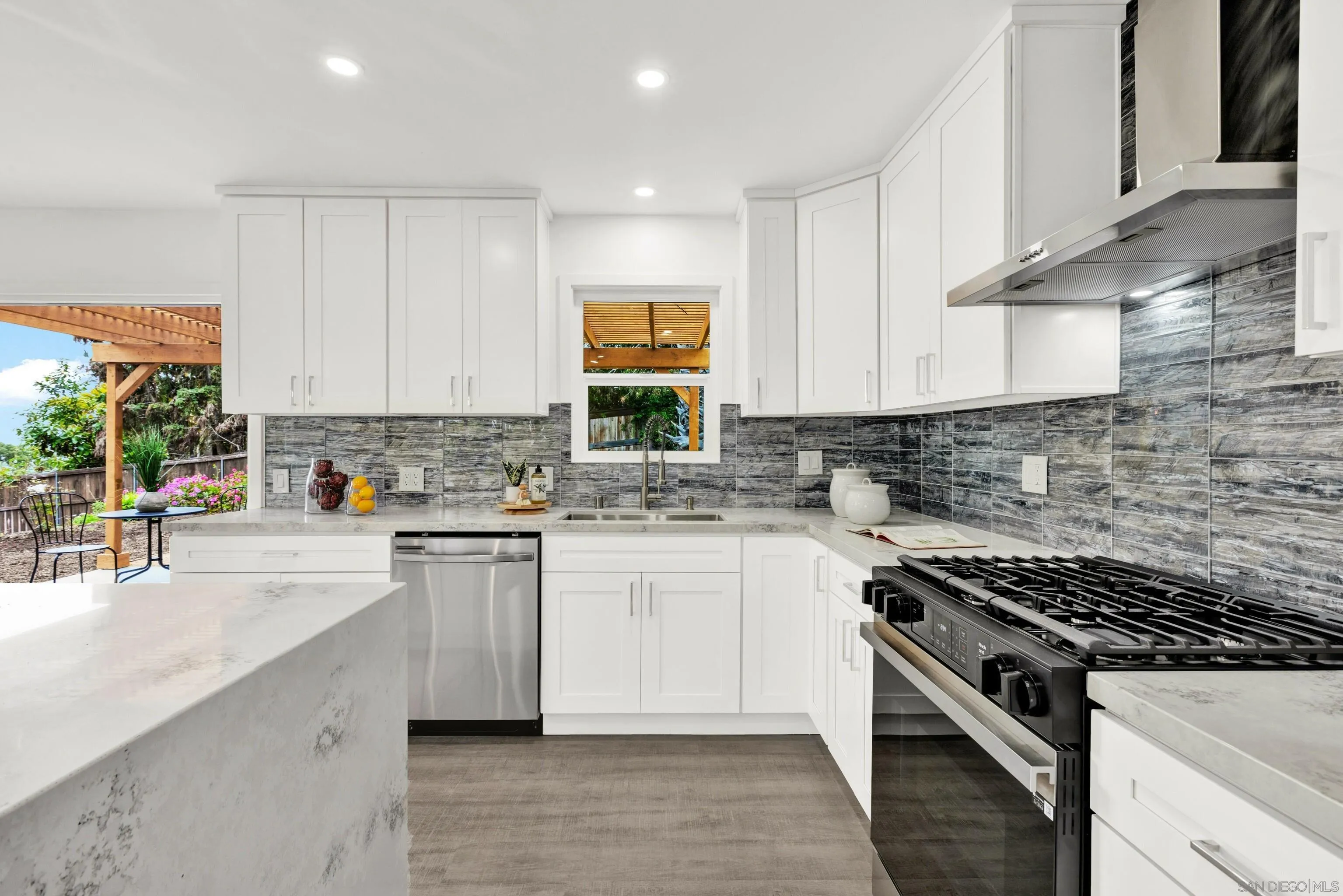 2250 Ivy Road Oceanside, CA 92054 - Photo 10 of 30 a kitchen with granite countertop a sink stove and cabinets