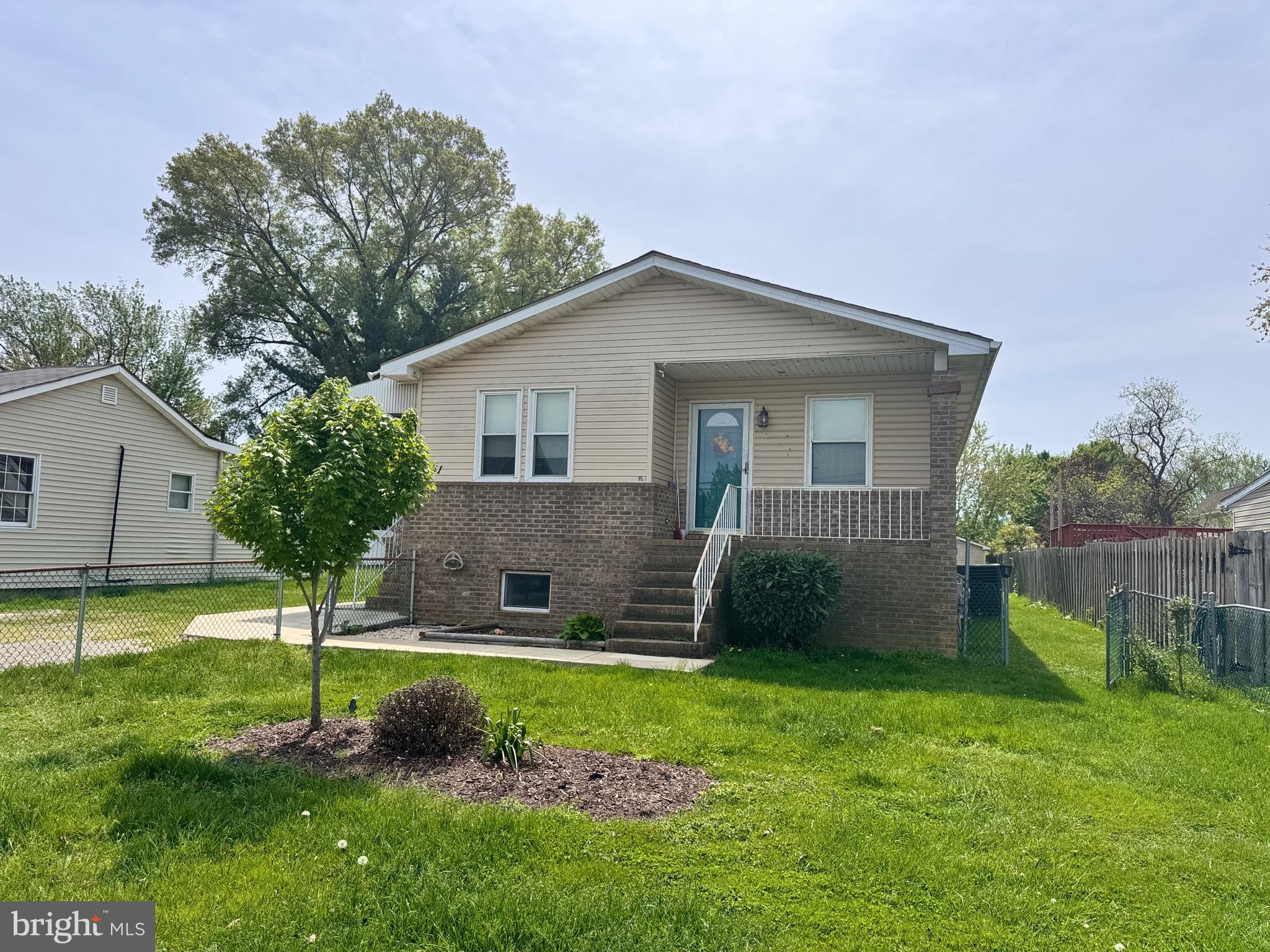 a front view of a house with a yard and a garage