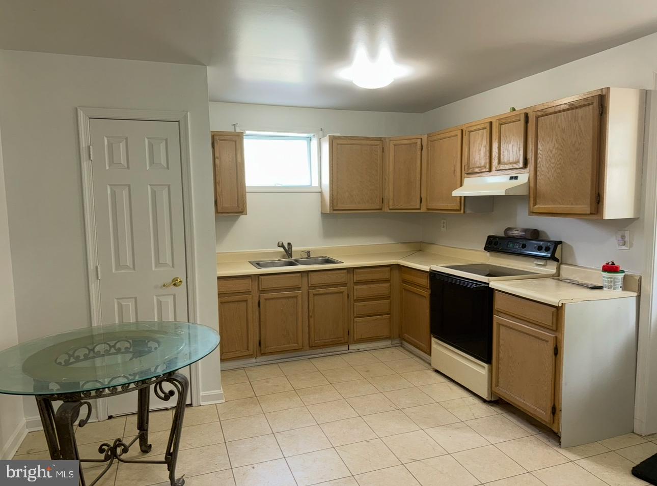 7341 Waldman Avenue Sparrows Point, MD 21219 - Photo 7 of 15 a kitchen with a stove a sink cabinets and a window