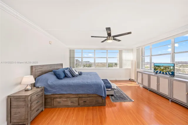 a living room with a bed furniture and a large window