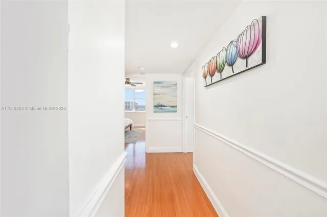 a view of a hallway with wooden floor