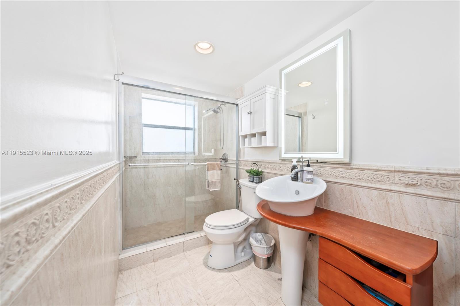 2100 Sans Souci Boulevard, Unit B1006 North Miami, FL 33181 - Photo 23 of 40 a bathroom with a toilet sink and mirror