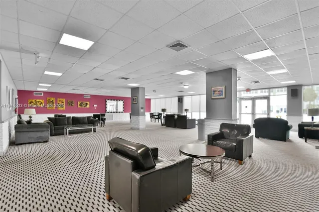 a living room with furniture a rug and a chandelier