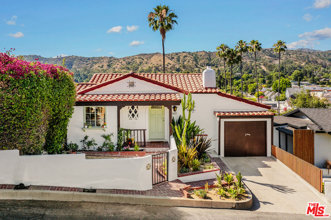 a front view of a house with a garden