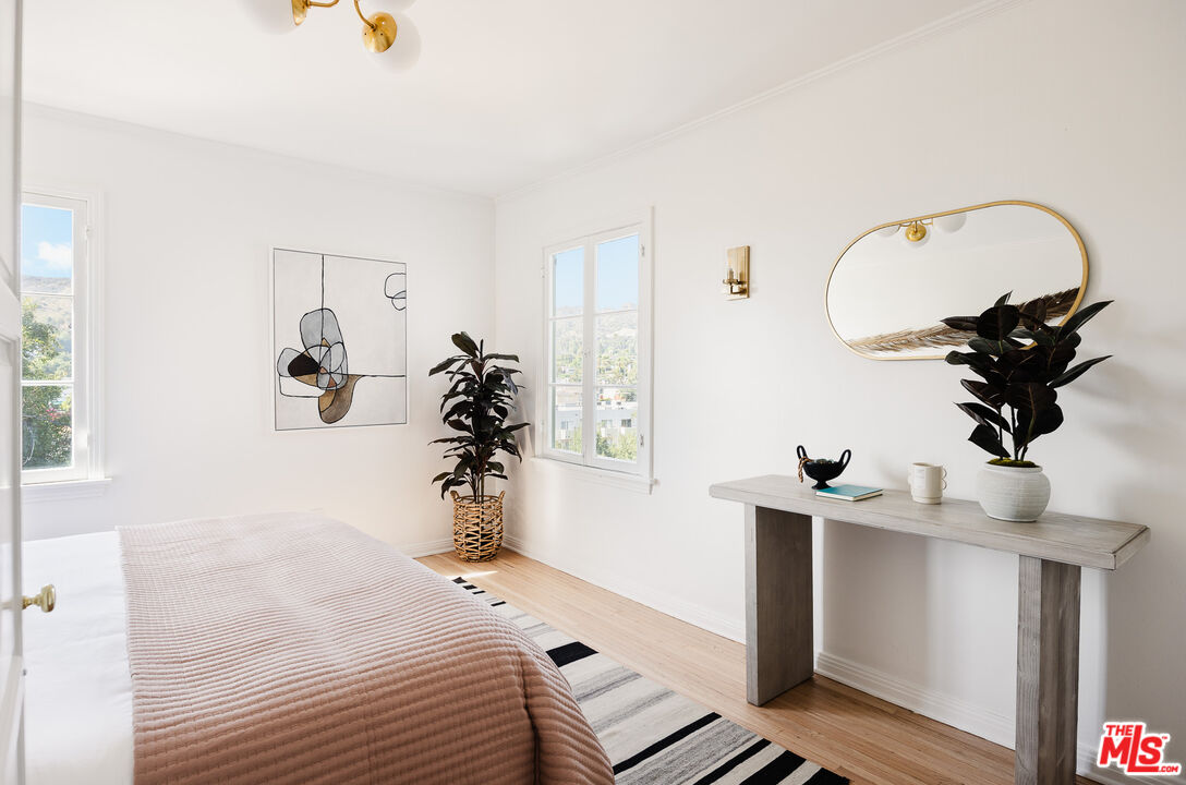 1817 Oak Tree Drive Los Angeles, CA 90041 - Photo 4 of 6 a bedroom with a bed and a chandelier