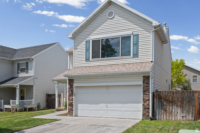 1346 Archmore Drive Springville, UT 84663 - Photo 29 of 32 Two-story residence featuring light-colored siding, a prominent two-car garage, and stone veneer accents