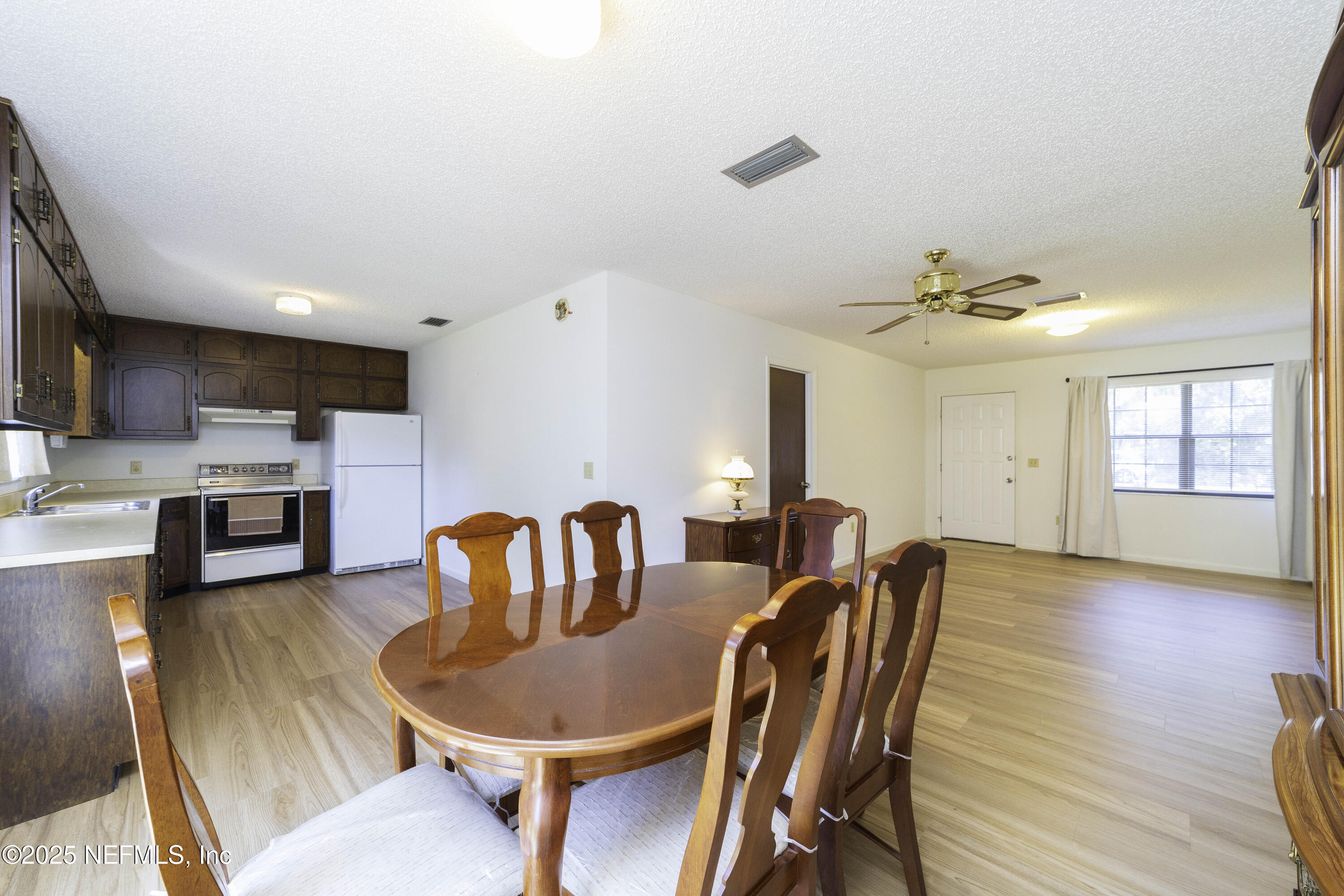 103 Indian Mound Road Satsuma, FL 32189 - Photo 11 of 36 a dining room with furniture a chandelier and wooden floor