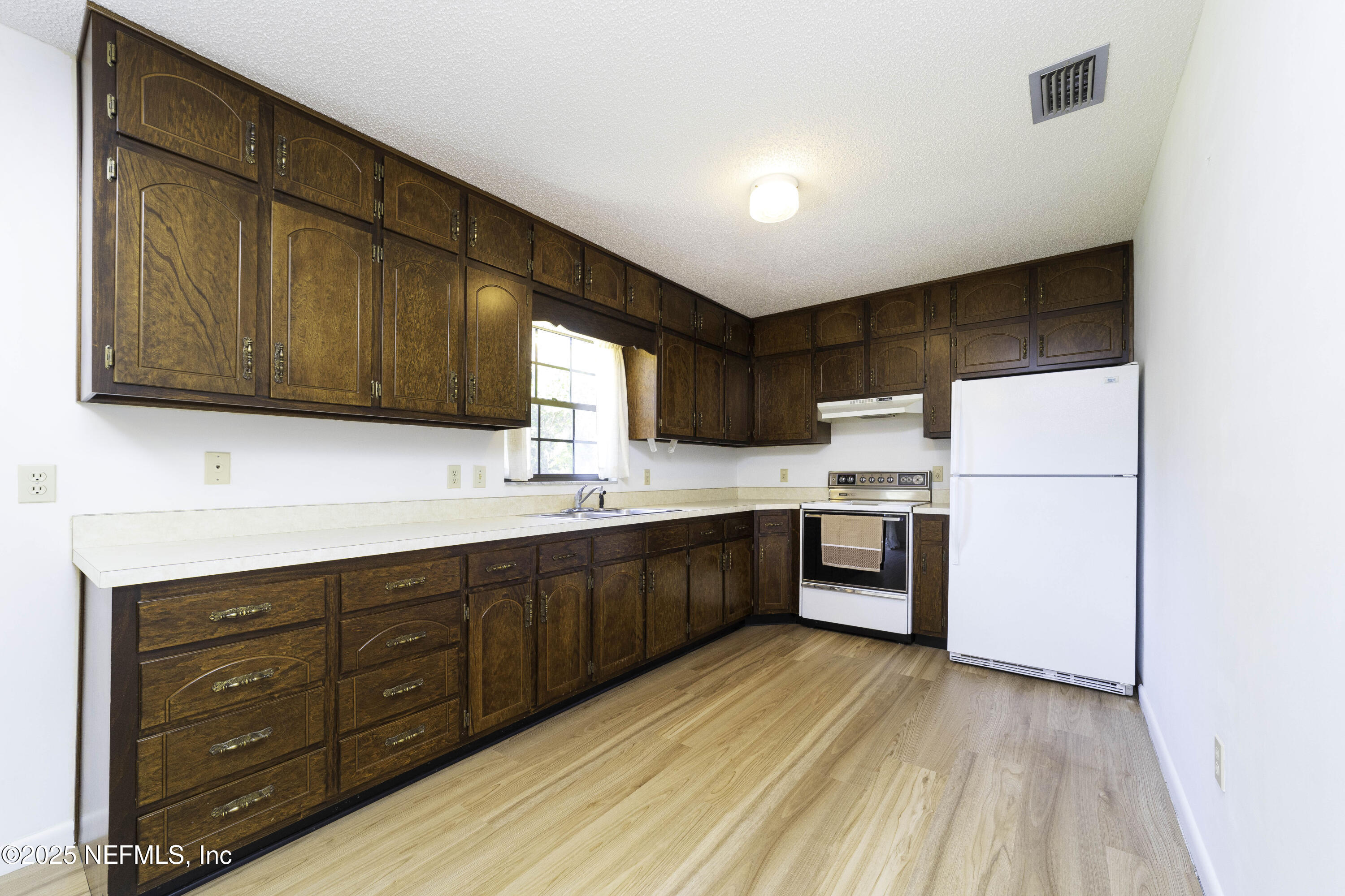 103 Indian Mound Road Satsuma, FL 32189 - Photo 12 of 36 a kitchen with stainless steel appliances granite countertop a refrigerator and cabinets
