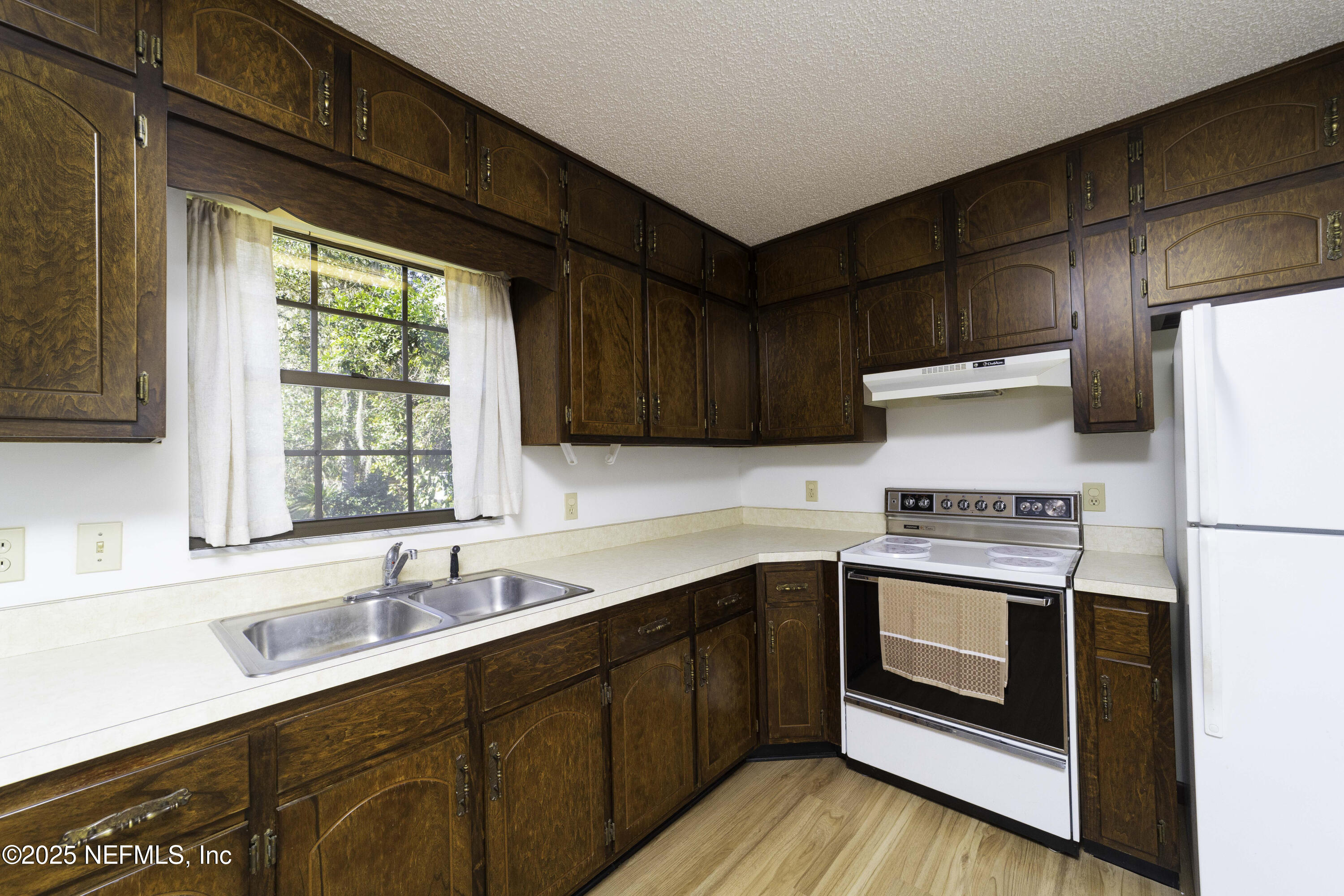 103 Indian Mound Road Satsuma, FL 32189 - Photo 13 of 36 a kitchen with a sink a stove and refrigerator