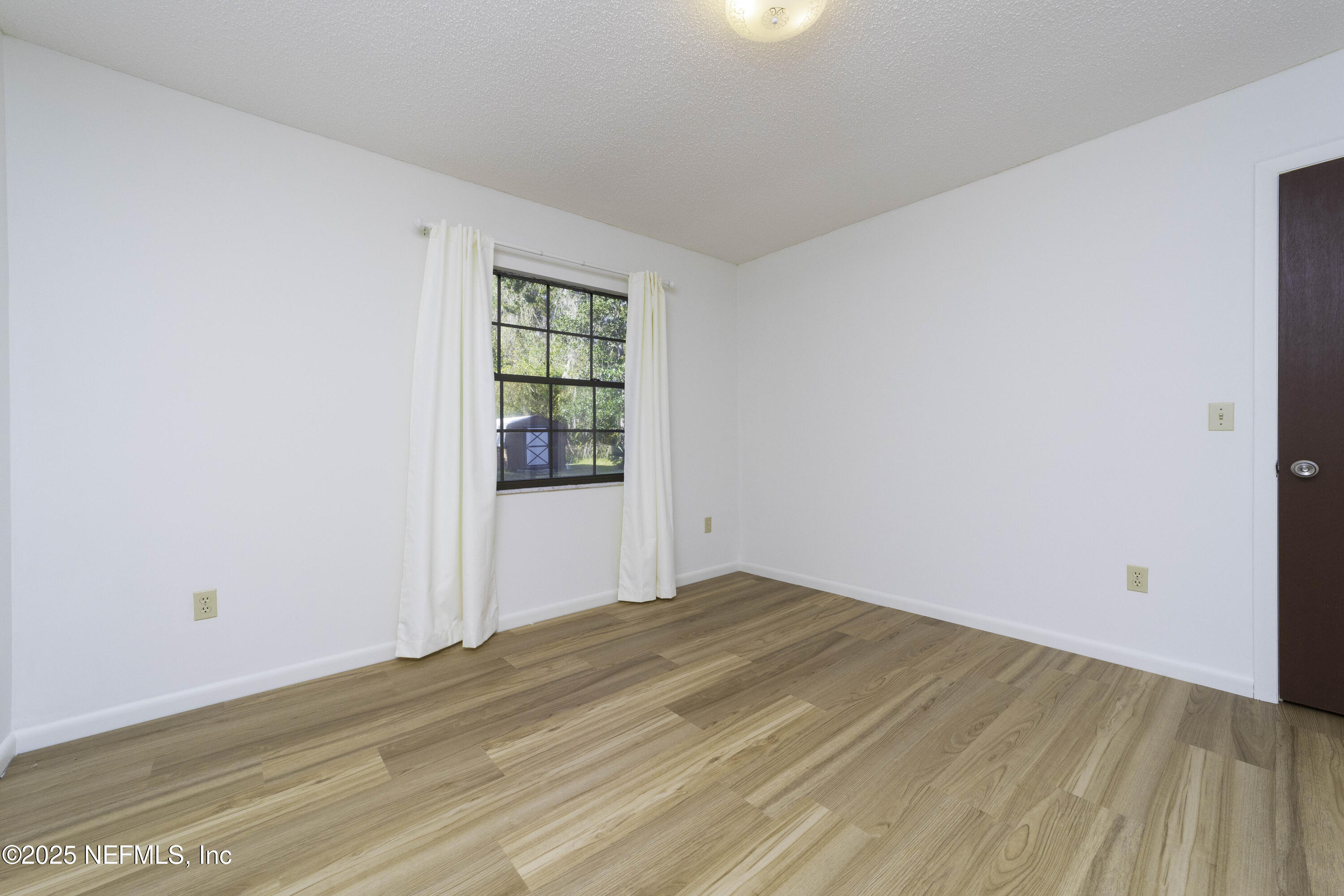 103 Indian Mound Road Satsuma, FL 32189 - Photo 21 of 36 a view of empty room with wooden floor and fan
