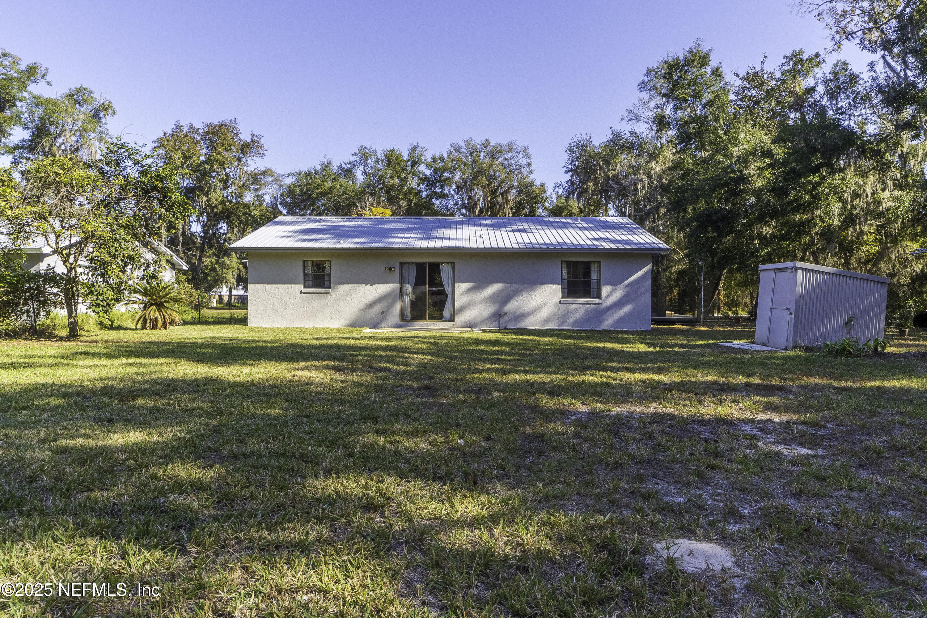103 Indian Mound Road Satsuma, FL 32189 - Photo 28 of 36 a front view of house with yard and trees in the background