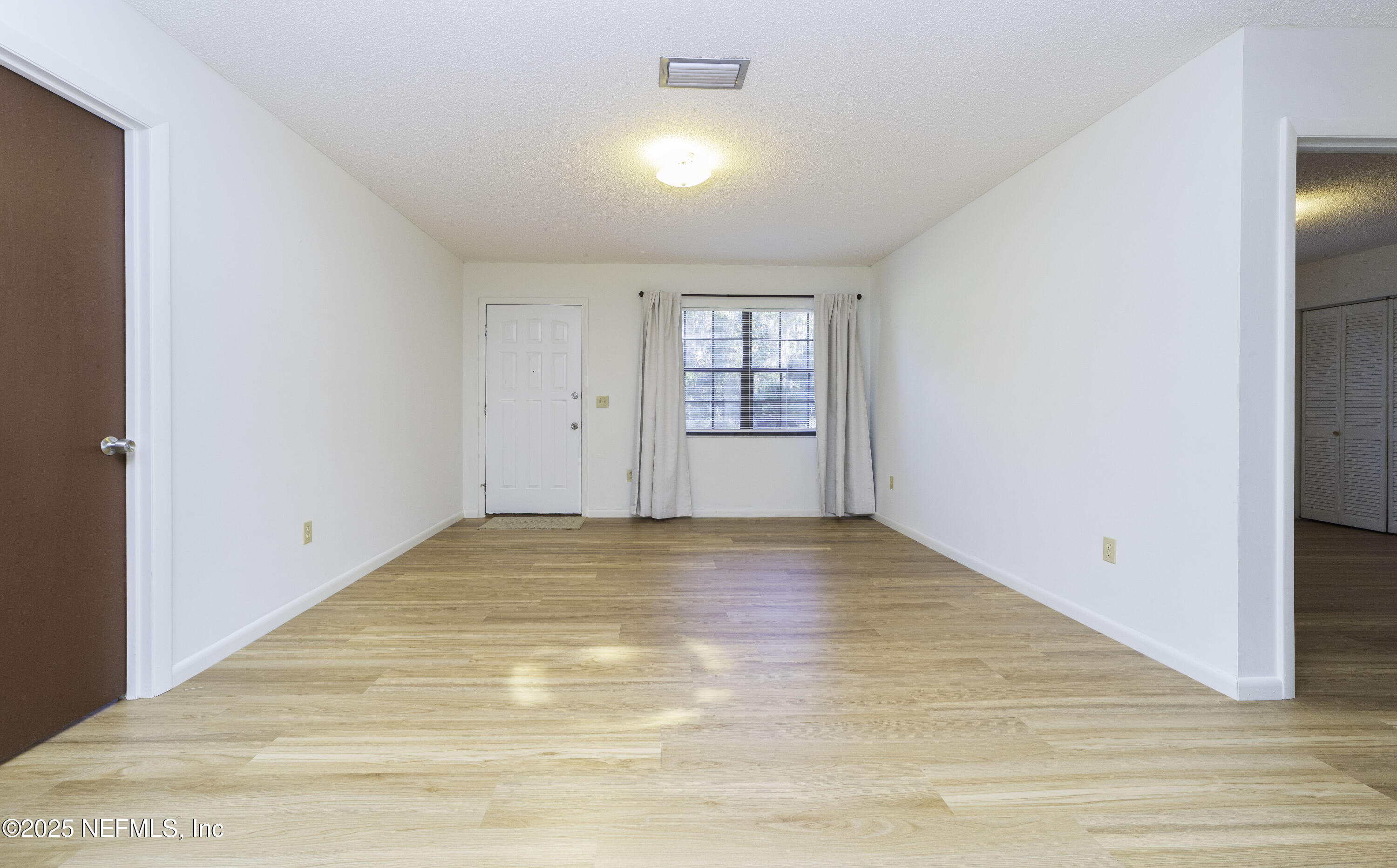 103 Indian Mound Road Satsuma, FL 32189 - Photo 5 of 36 a view of empty room with wooden floor and fan