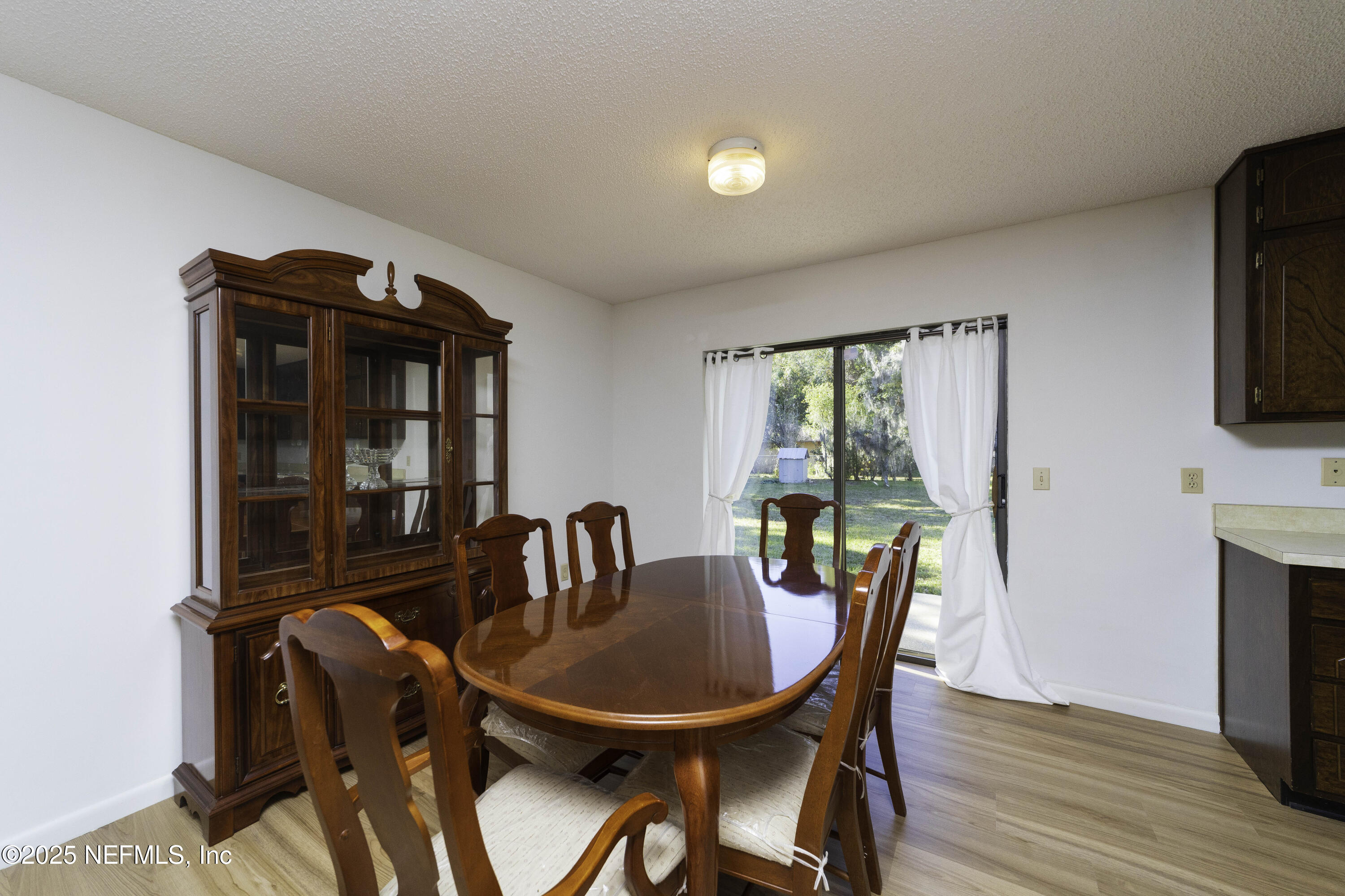 103 Indian Mound Road Satsuma, FL 32189 - Photo 9 of 36 a view of a dining room with furniture window and wooden floor