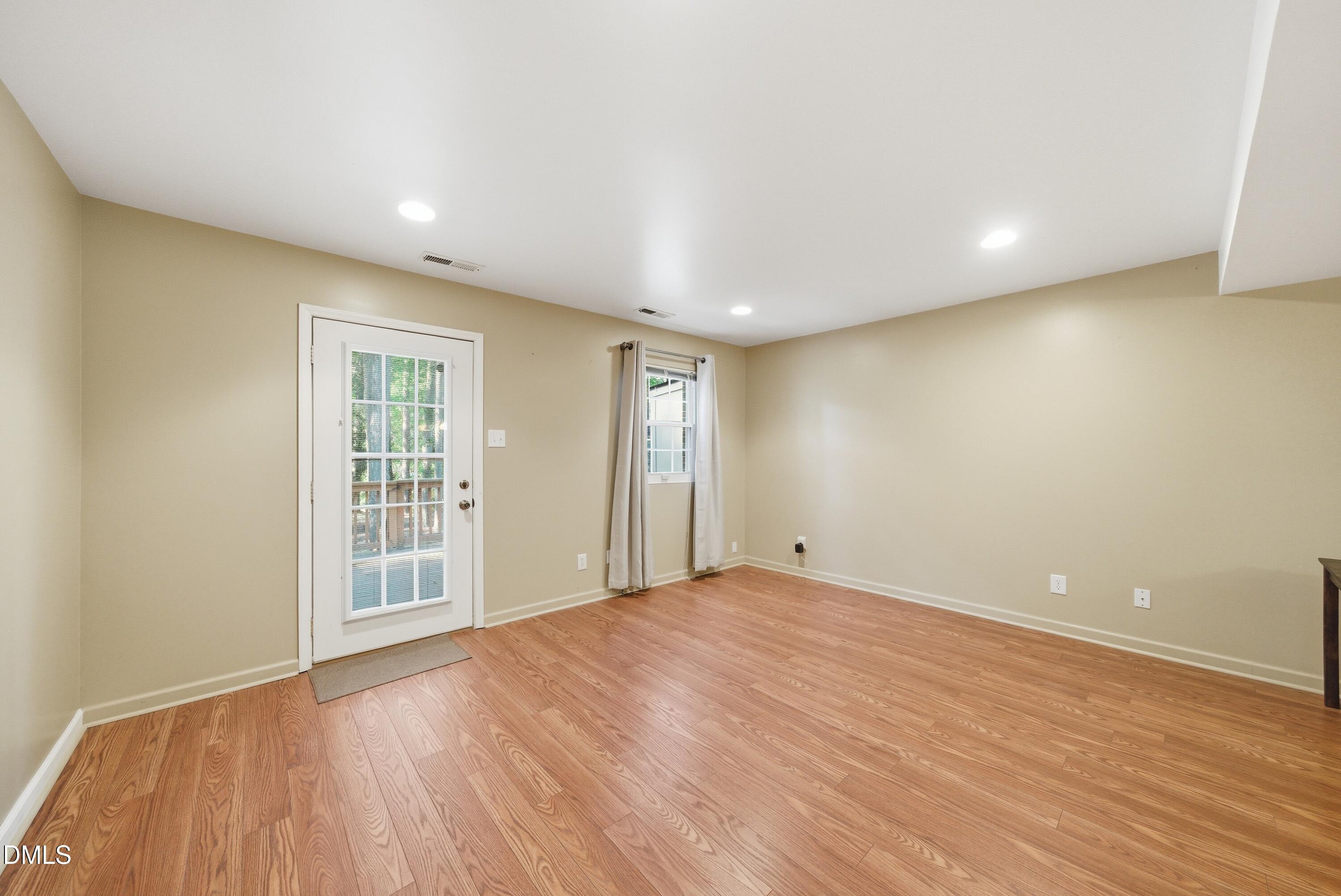 6355 New Market Way Raleigh, NC 27615 - Photo 17 of 30 a view of an empty room with wooden floor and a window