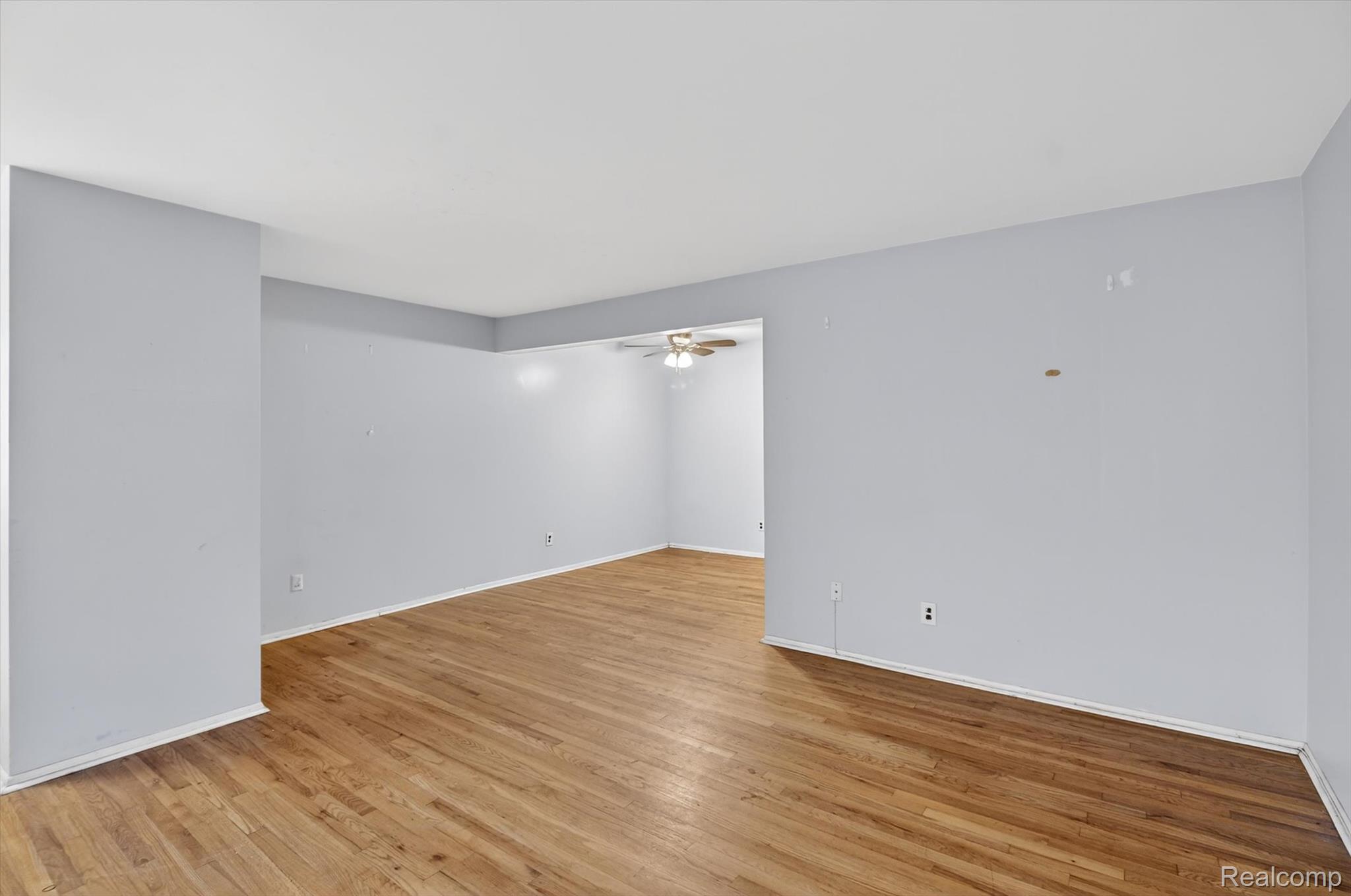 25301 Five Mile Road, Unit 109 Redford, MI 48239 - Photo 9 of 22 Unfurnished room featuring light wood-style flooring and a ceiling fan