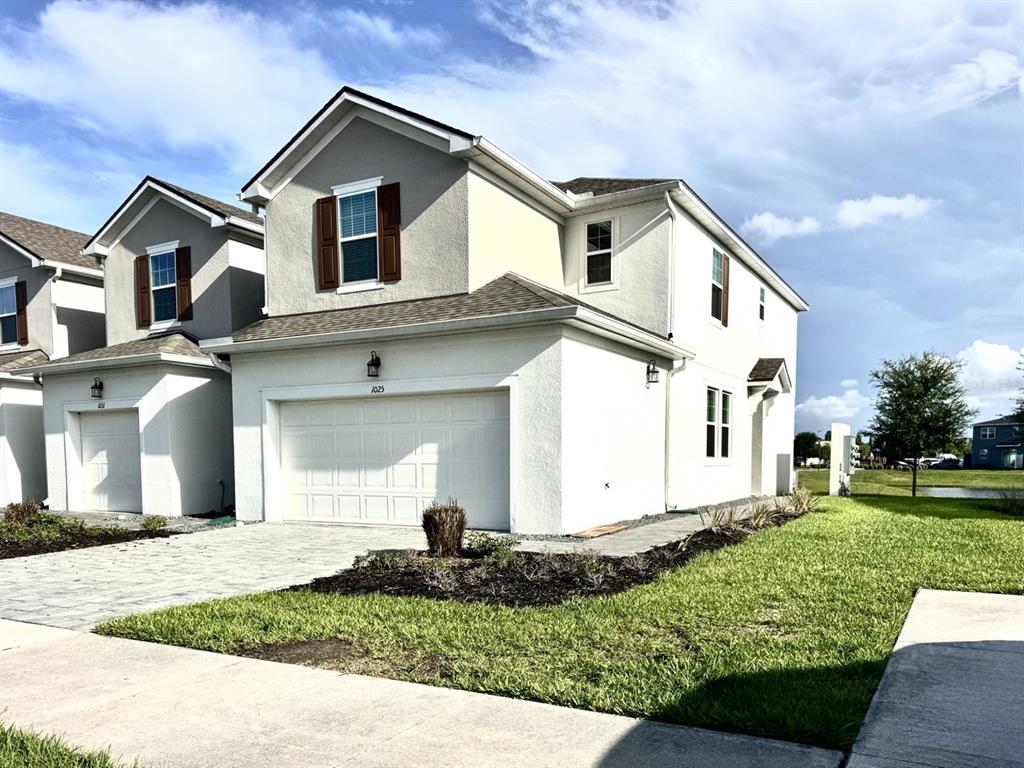 1025 Spring Palms Loop Orlando, FL 32828 - Photo 2 of 9 a front view of a house with a yard