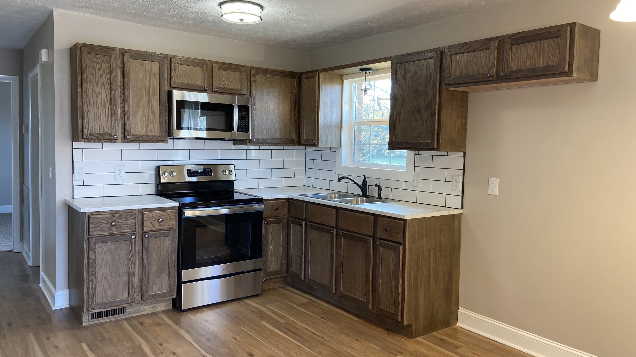 854 Jackson Road Portland, TN 37148 - Photo 3 of 11 a kitchen with stainless steel appliances granite countertop a sink and a microwave