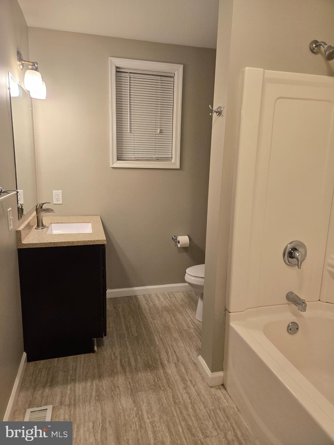 20 South Chestnut Street, Unit 1 Boyertown, PA 19512 - Photo 13 of 15 a bathroom with a sink a toilet and shower