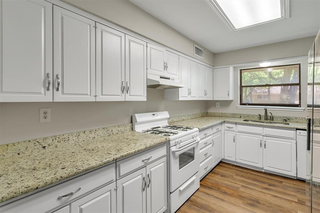 209 Mistletoe Lane Keene, TX 76059 - Photo 14 of 38 a kitchen with granite countertop white cabinets and a sink