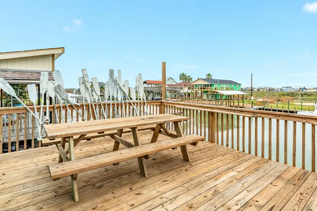 a view of a balcony with wooden chairs