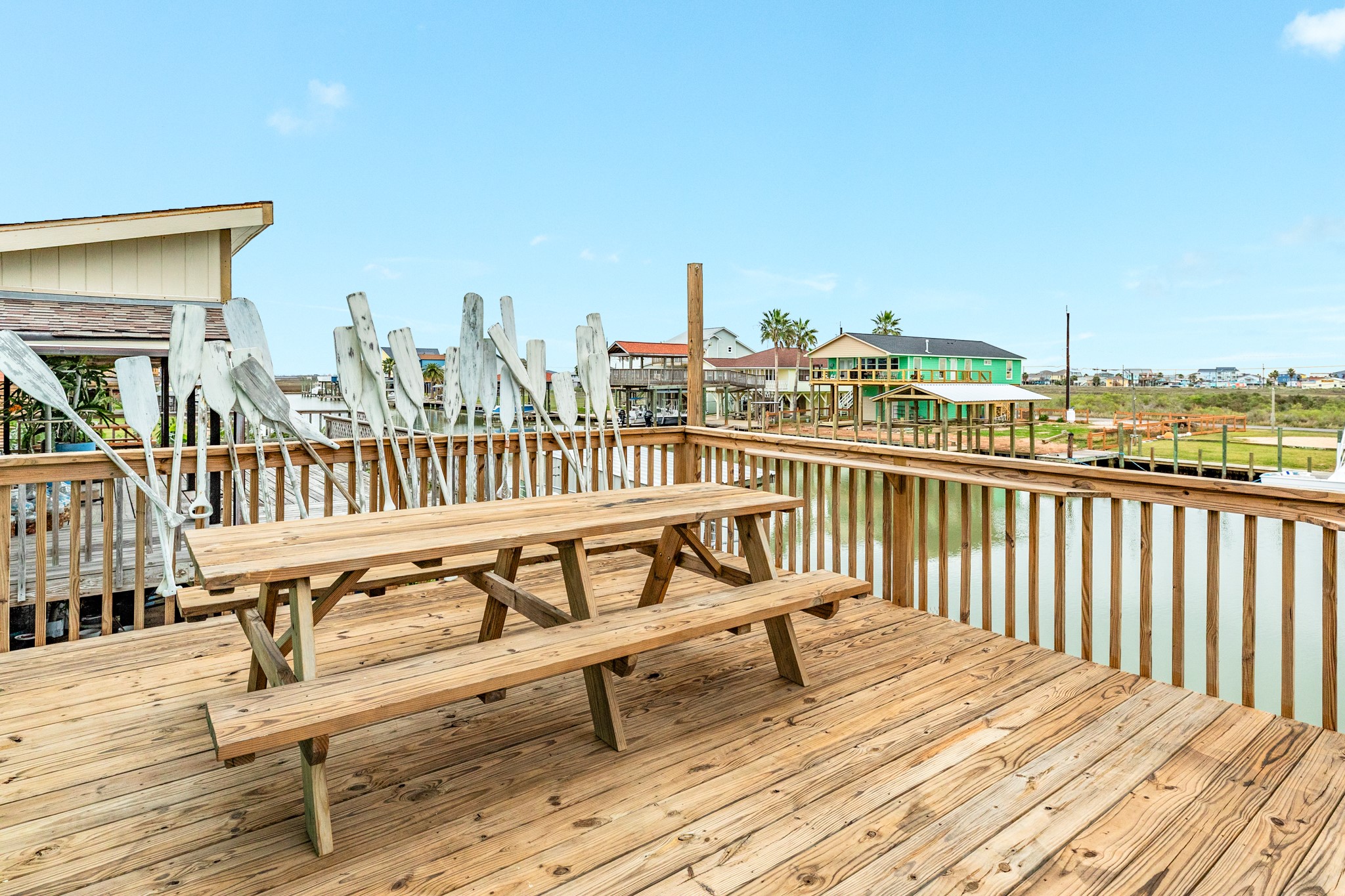 306 Pompano Lane Surfside Beach, TX 77541 - Photo 12 of 37 a view of a balcony with wooden chairs