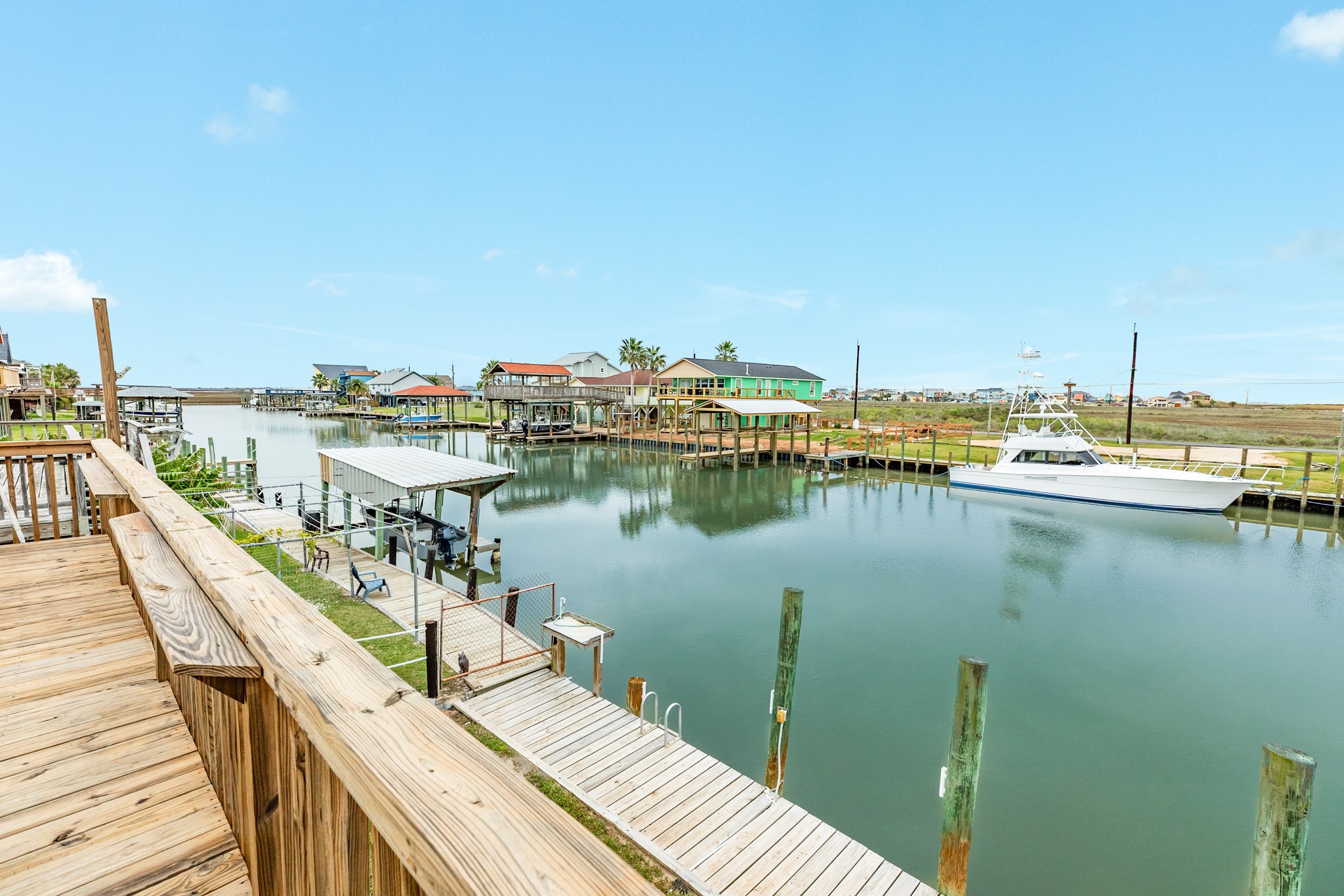 306 Pompano Lane Surfside Beach, TX 77541 - Photo 13 of 37 a view of a lake with wooden bridge