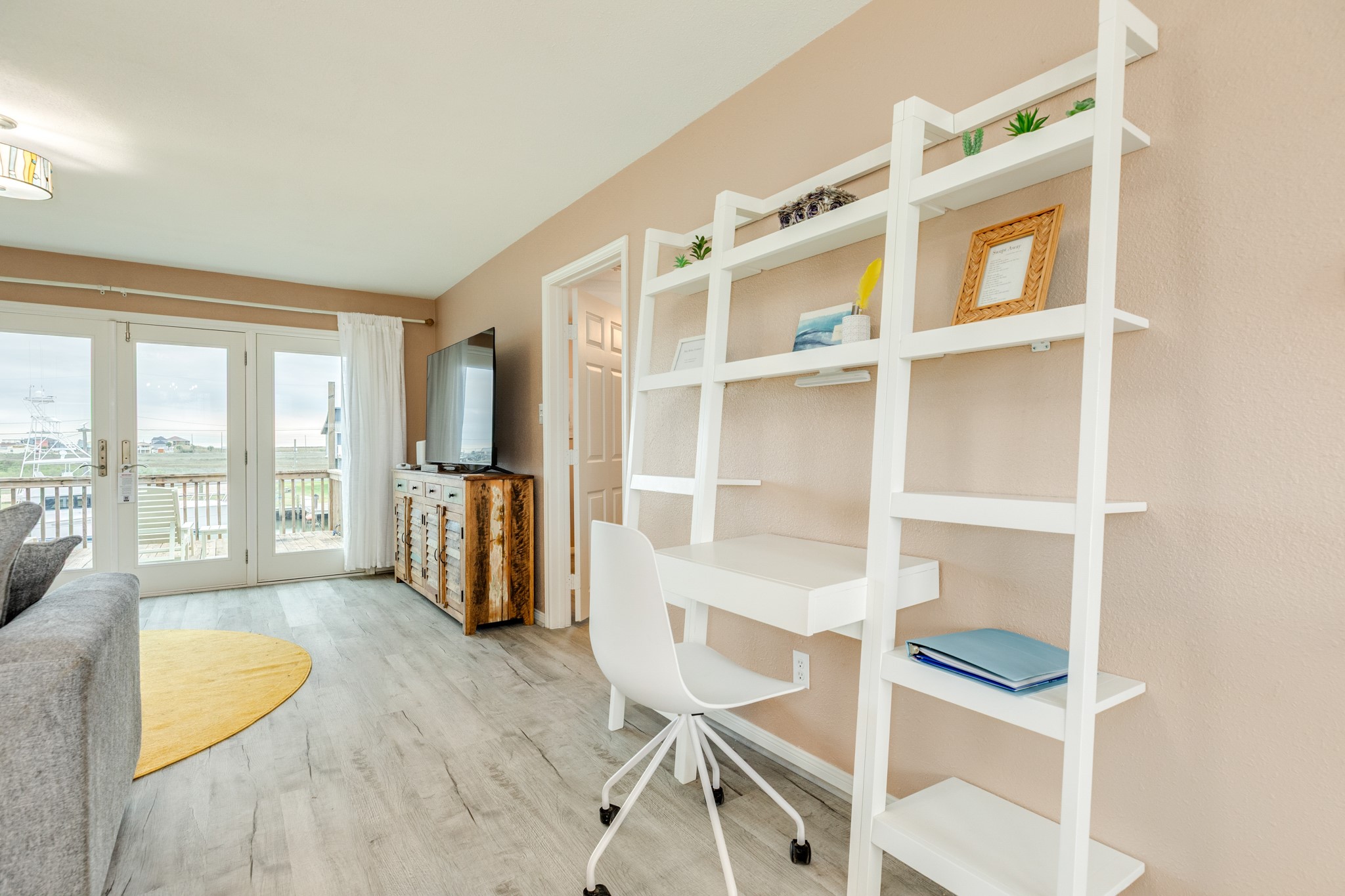 306 Pompano Lane Surfside Beach, TX 77541 - Photo 17 of 37 a view of an empty room with wooden floor and a window