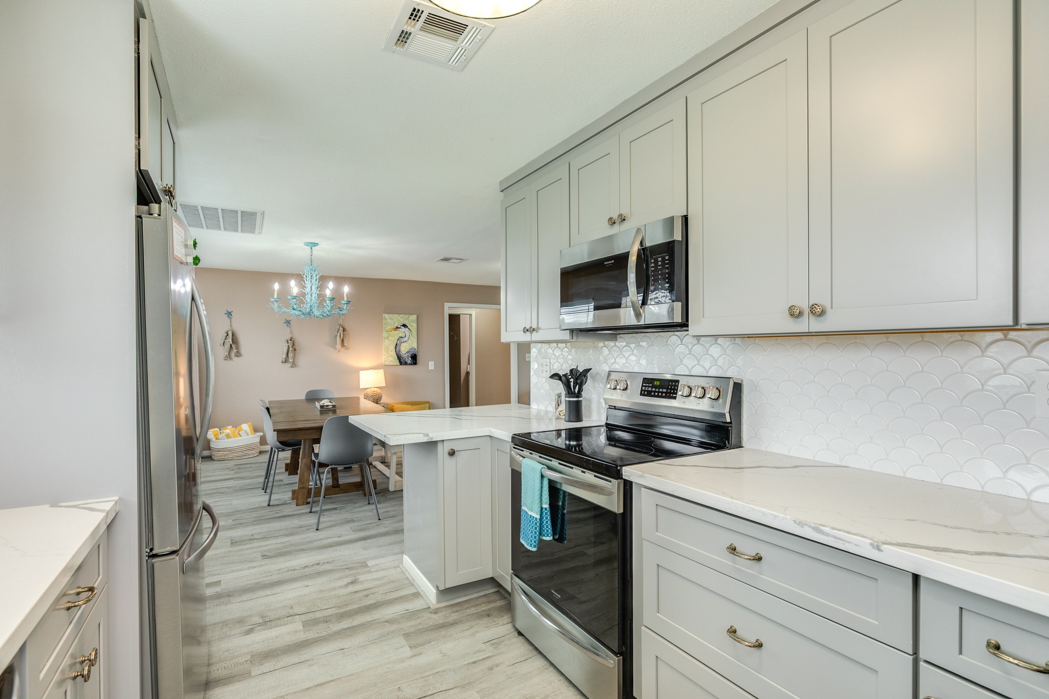 306 Pompano Lane Surfside Beach, TX 77541 - Photo 20 of 37 a kitchen with appliances a sink and cabinets