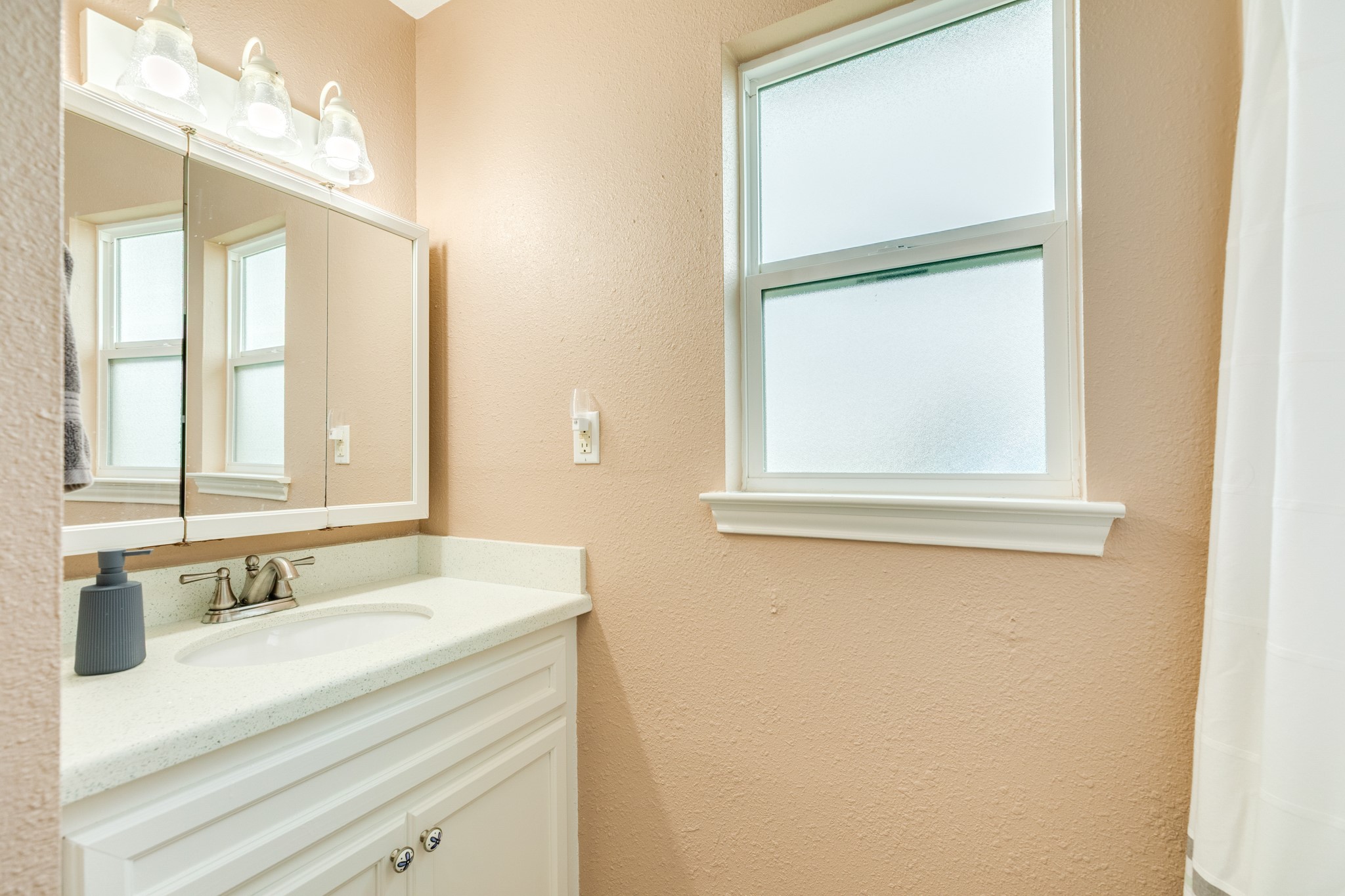 306 Pompano Lane Surfside Beach, TX 77541 - Photo 22 of 37 a bathroom with a sink and a mirror