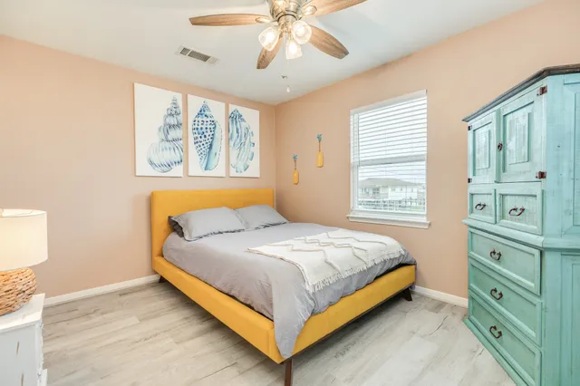 a bedroom with a large bed and a window